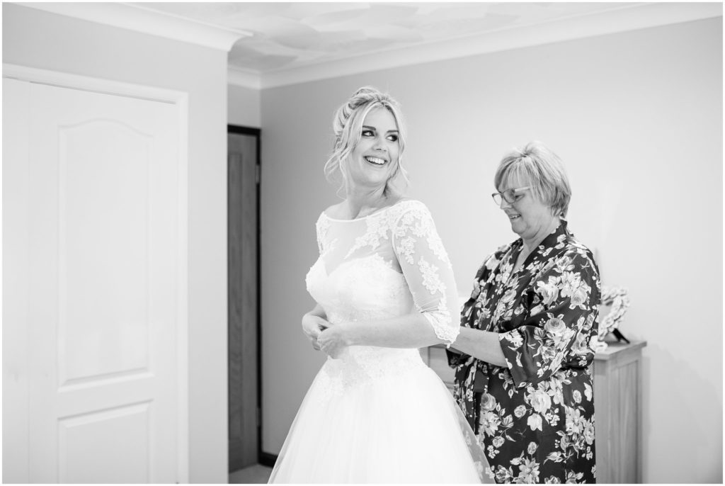 Bride getting into wedding dress