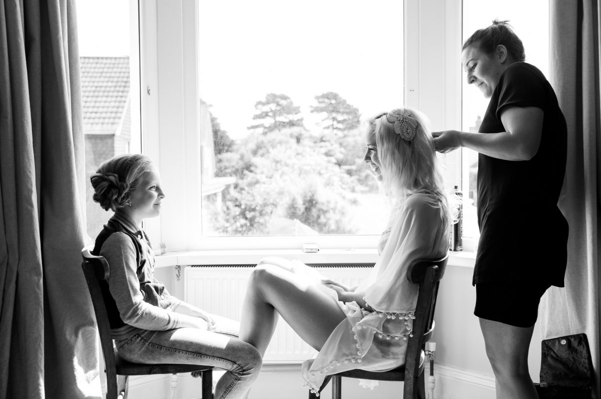 Bride and bridesmaid getting ready for wedding
