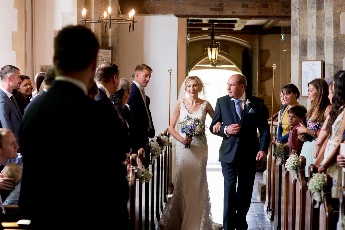Bride walking in with father on wedding day
